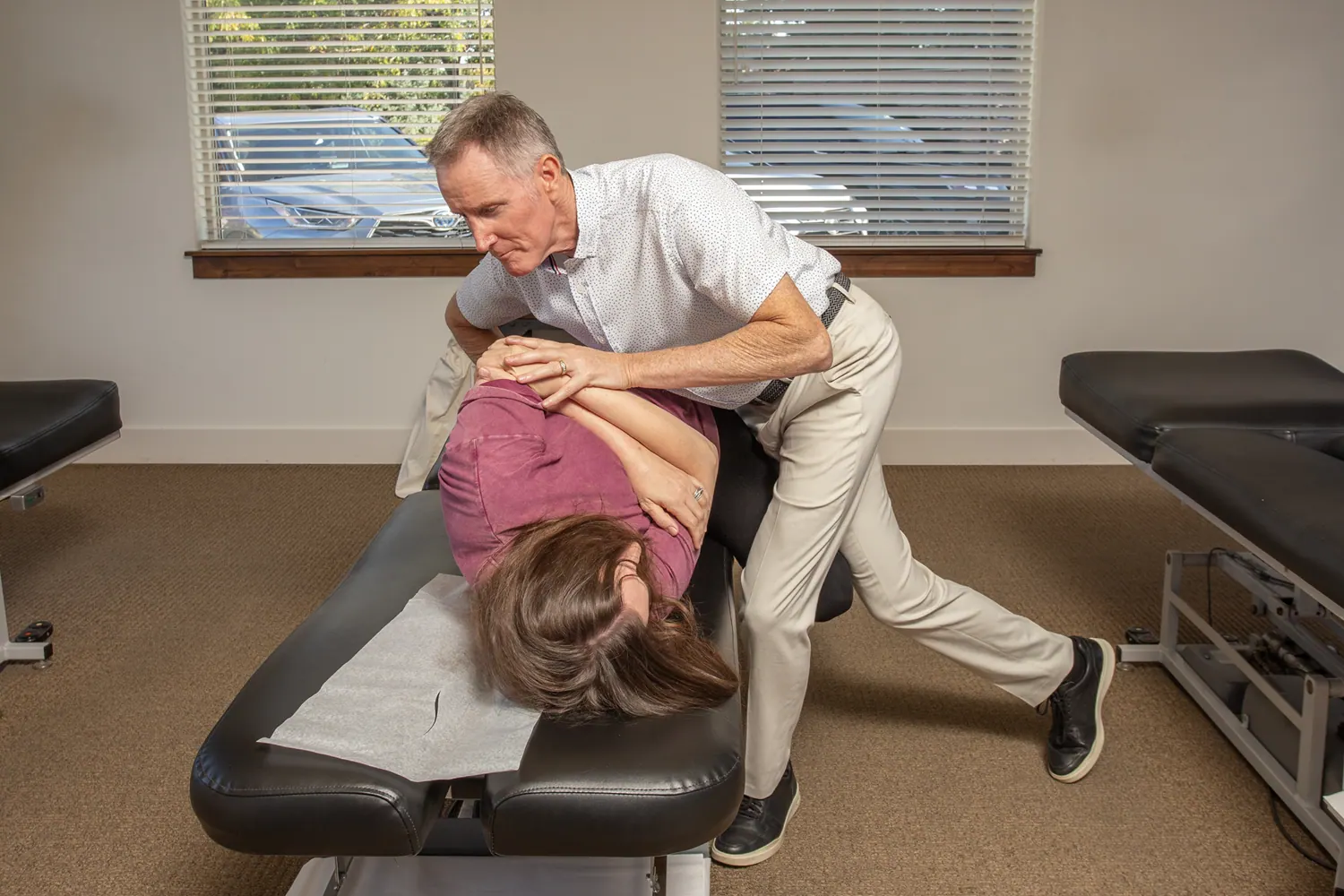 Dr. Craig Ellison performing a side-posture low back adjustment