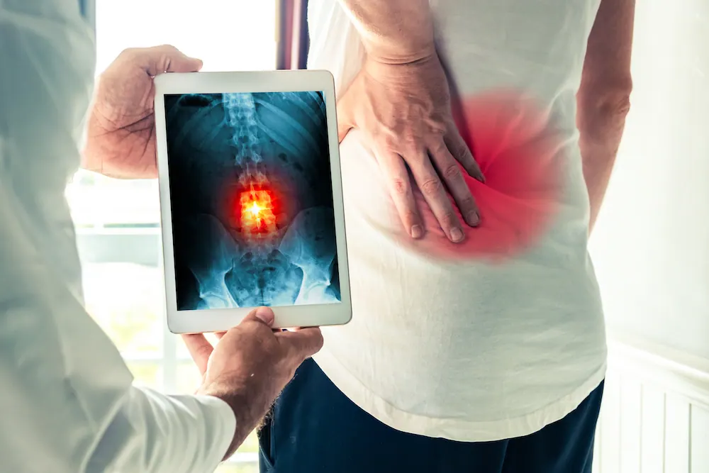 doctor showing patient digital spine result