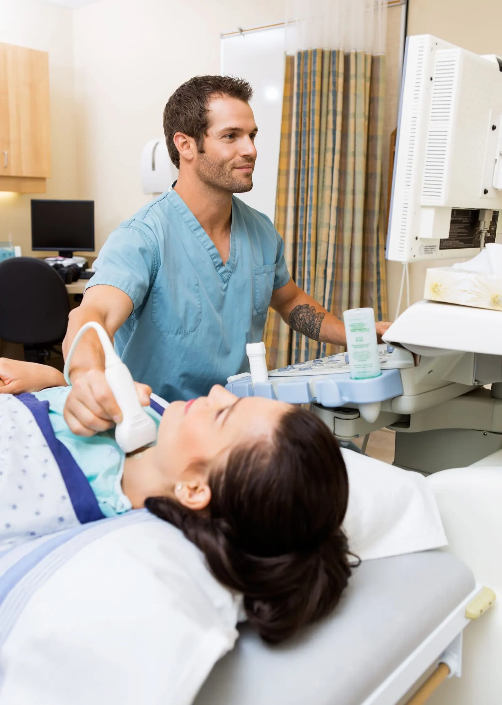 doctor having ultrasound on patients thyroid